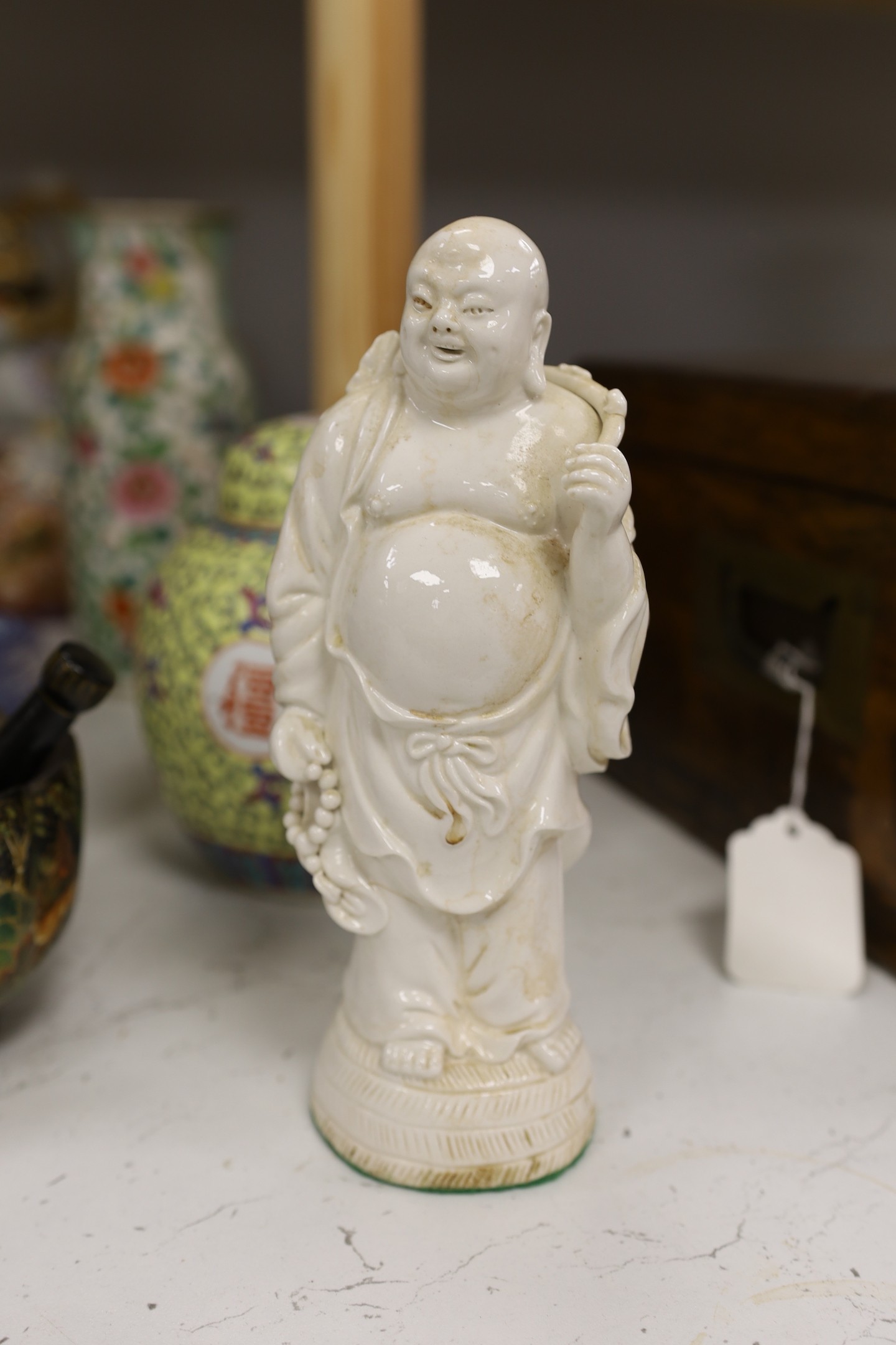A collection of mostly Chinese ceramics, to include a vase, a lion dog, pestle and mortar etc.
